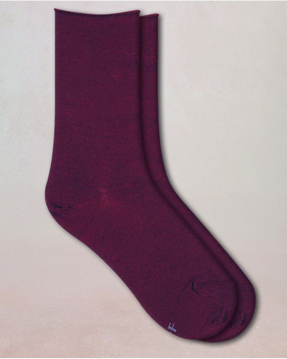 Pair of purple socks on a beige background
