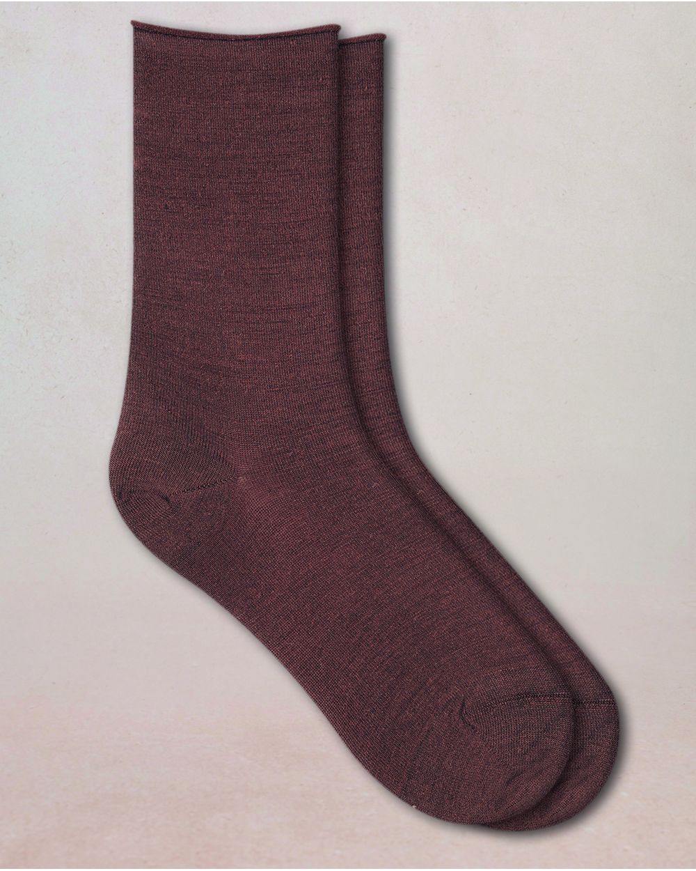 Pair of maroon socks on a beige background