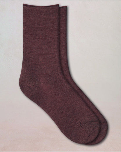 Pair of maroon socks on a beige background